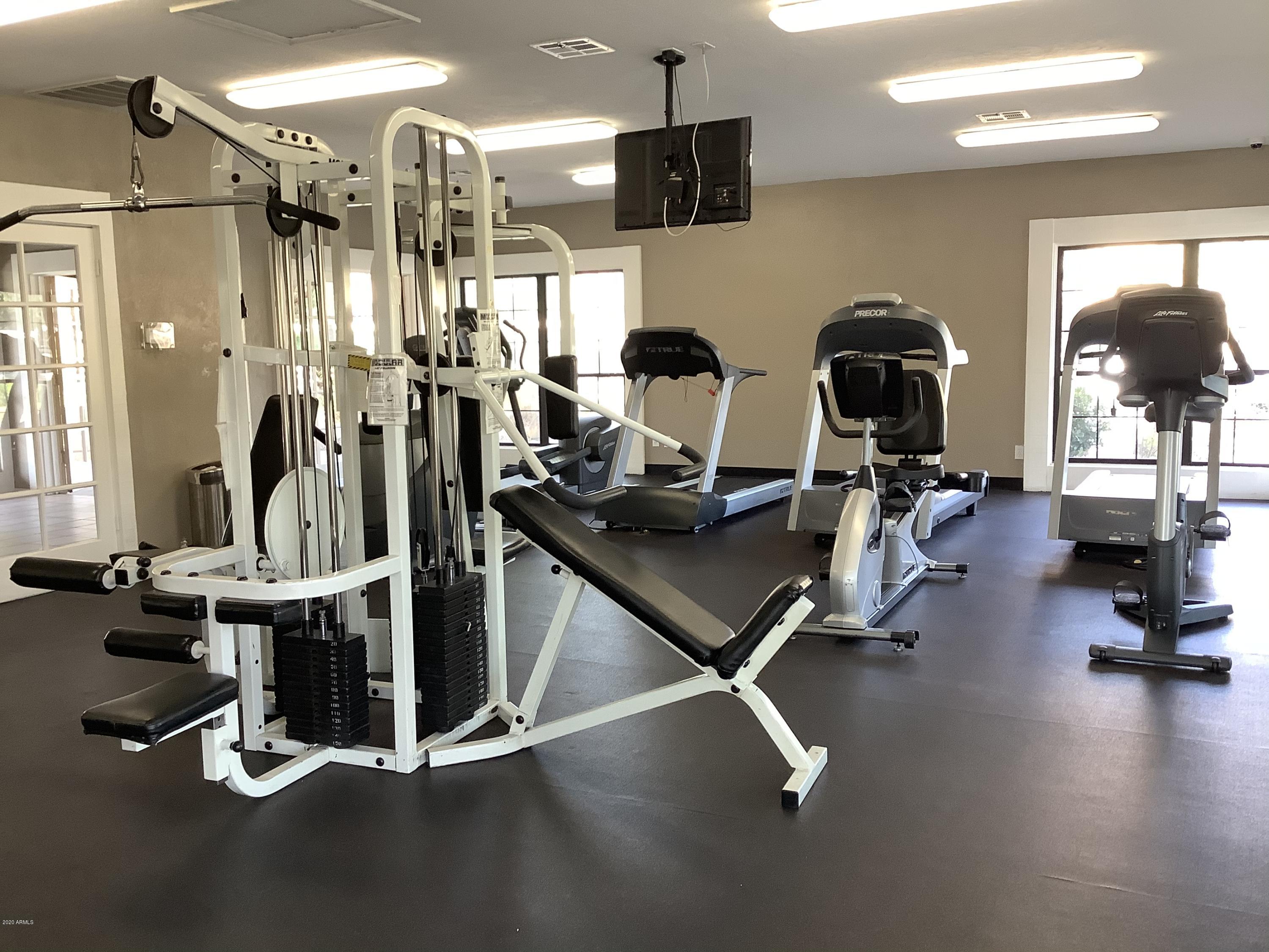 8787 East Mountain View Road, Unit 1034 Scottsdale, AZ 85258 - Photo 34 of 43 a room with gym equipment and large mirror