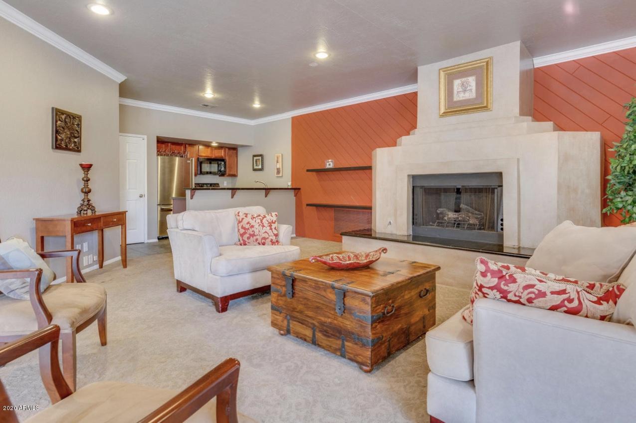 8787 East Mountain View Road, Unit 1034 Scottsdale, AZ 85258 - Photo 35 of 43 a bedroom with furniture and a fireplace