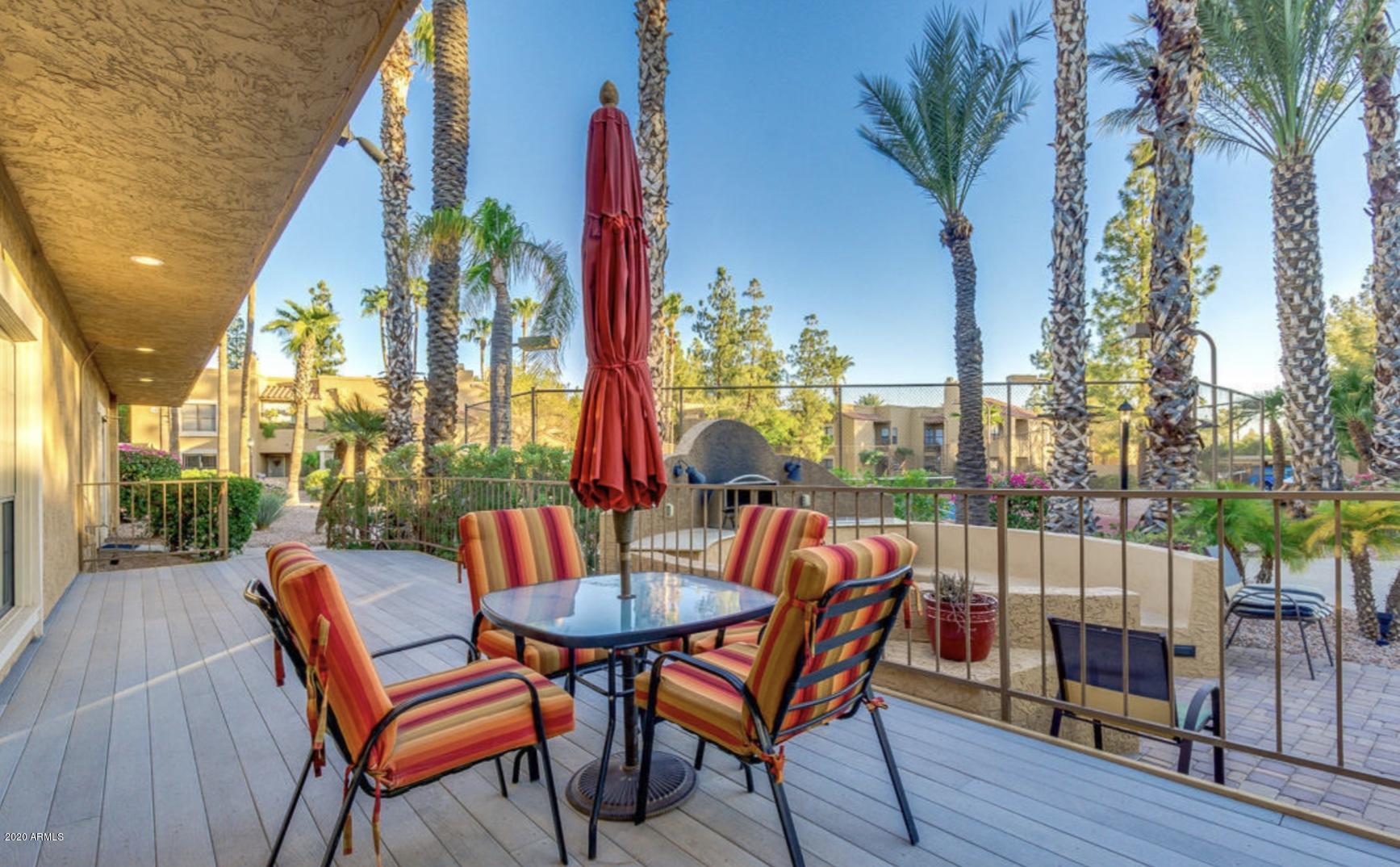 8787 East Mountain View Road, Unit 1034 Scottsdale, AZ 85258 - Photo 37 of 43 a view of an outdoor sitting area with furniture and wooden floor