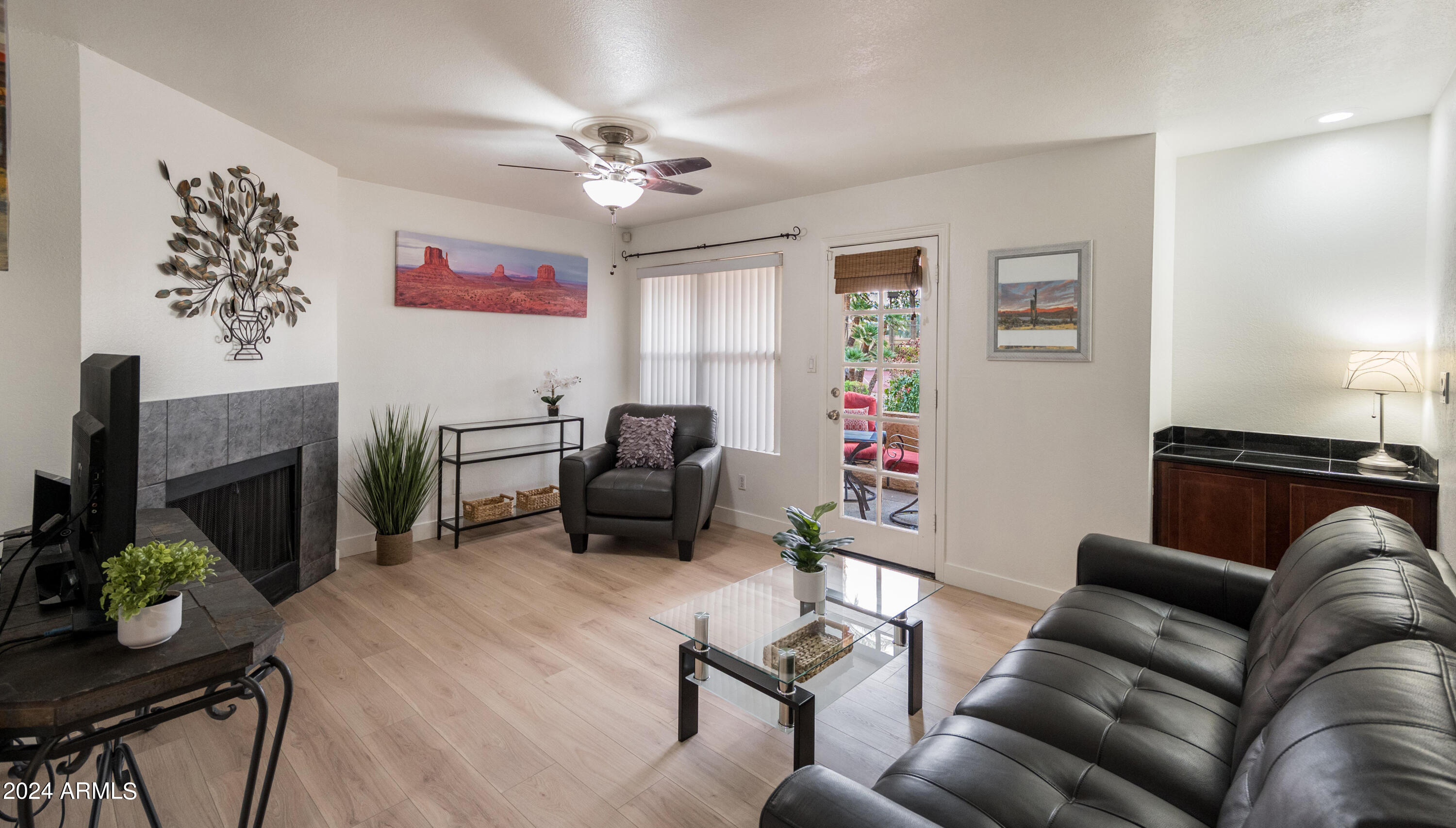 8787 East Mountain View Road, Unit 1034 Scottsdale, AZ 85258 - Photo 6 of 43 a living room with furniture a fireplace and a flat screen tv