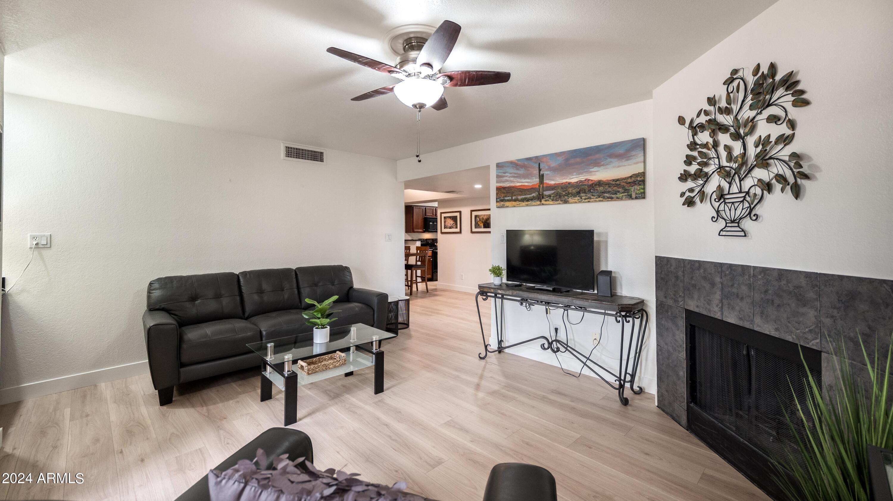 8787 East Mountain View Road, Unit 1034 Scottsdale, AZ 85258 - Photo 7 of 43 a living room with furniture and a flat screen tv