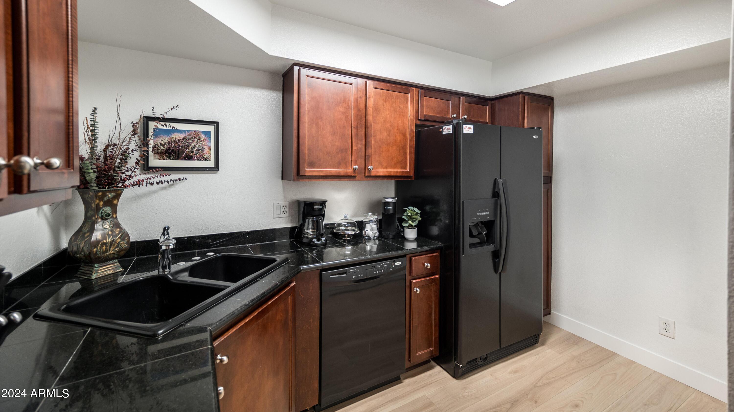 8787 East Mountain View Road, Unit 1034 Scottsdale, AZ 85258 - Photo 9 of 43 a kitchen with a sink stove and refrigerator