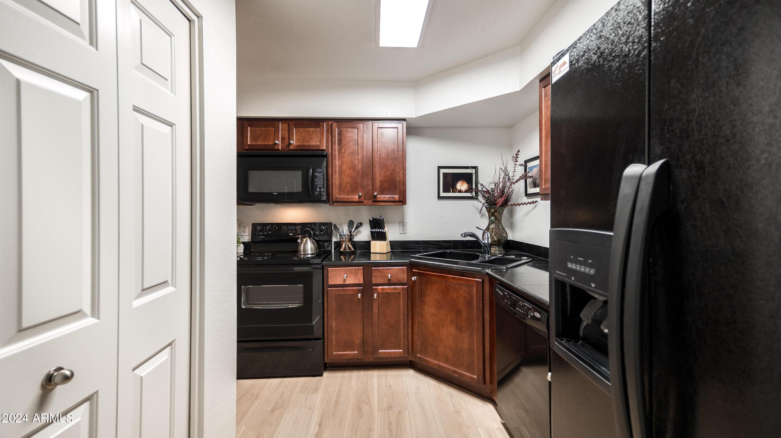 8787 East Mountain View Road, Unit 1034 Scottsdale, AZ 85258 - Photo 10 of 43 a kitchen with stainless steel appliances granite countertop a refrigerator and a stove