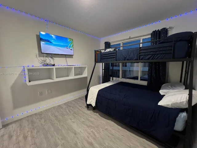 a bedroom with two beds and a chandelier