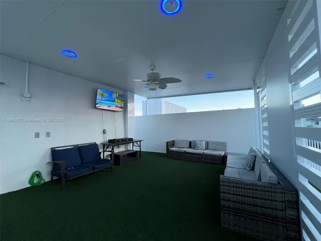 a living room with furniture and a garden