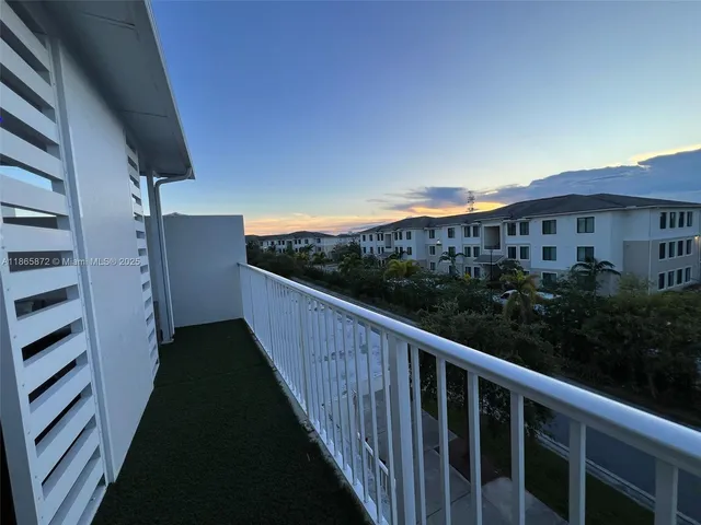 a view of a room with furniture and a window