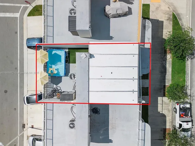 a front view of a building with parking space and windows