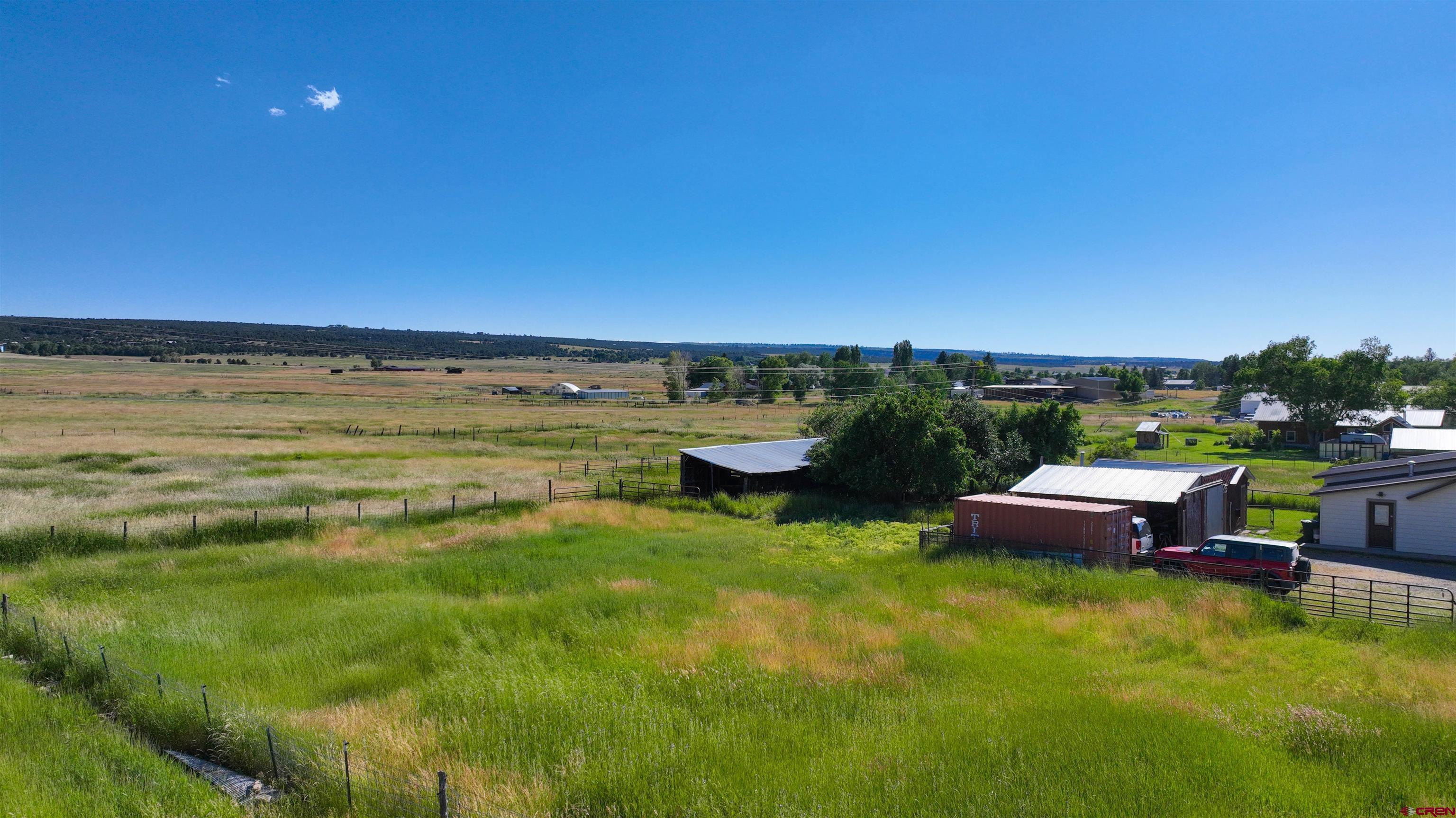 40977 Grand Avenue Norwood, CO 81423 - Photo 1 of 32 a view of a swimming pool with a lounge chair and a lake view
