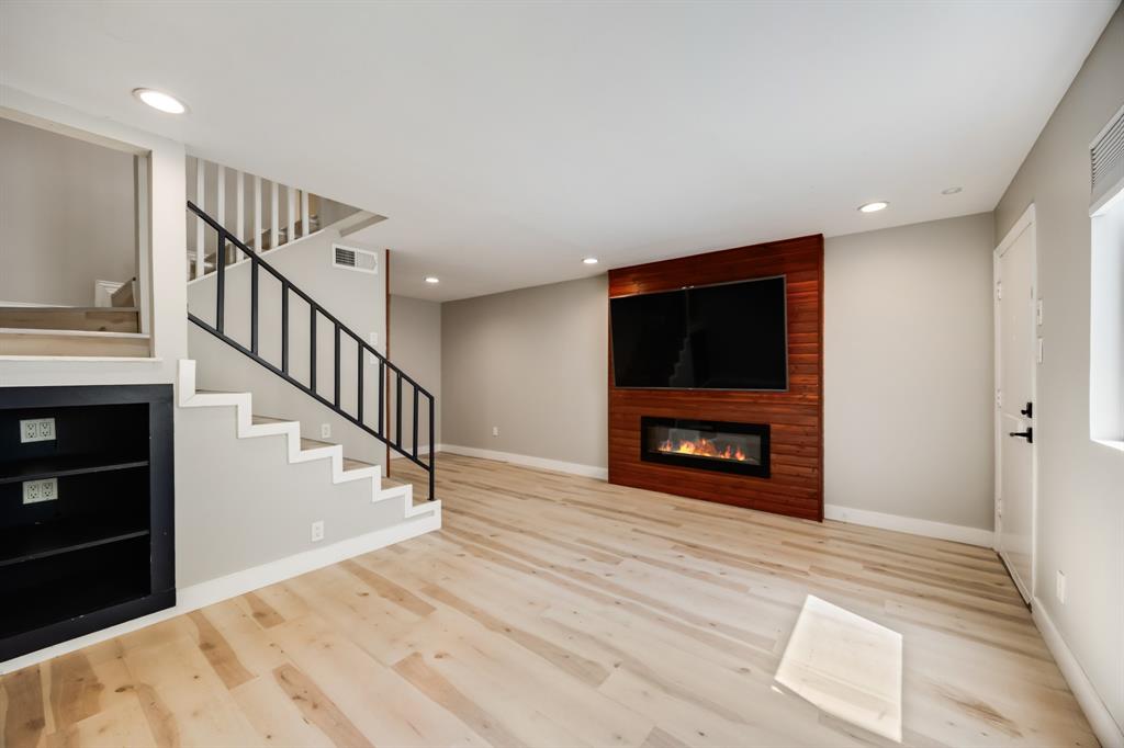 3500 Routh Street, Unit 6 Dallas, TX 75219 - Photo 2 of 17 Spacious living room with built in electric fireplace and 65" smart tv.