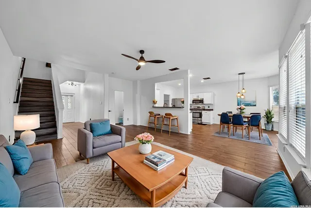 a living room with furniture and wooden floor