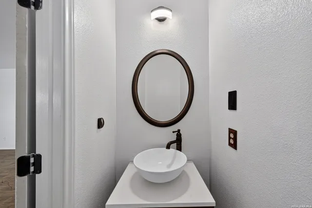 a bathroom with a toilet a sink and mirror