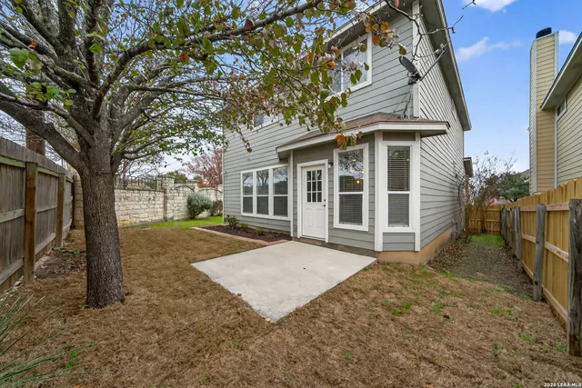 a view of a house with a yard and pathway