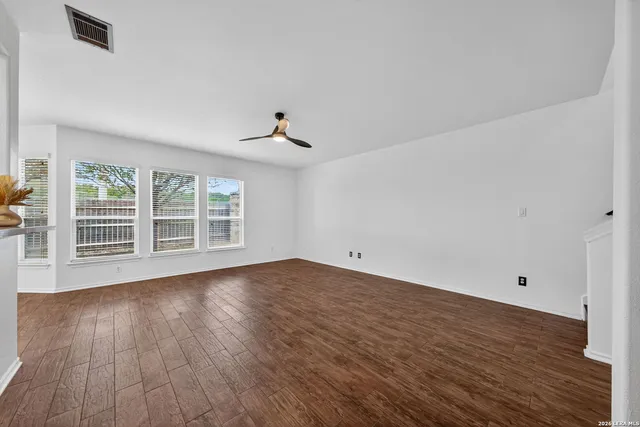 wooden floor in an empty room with a window
