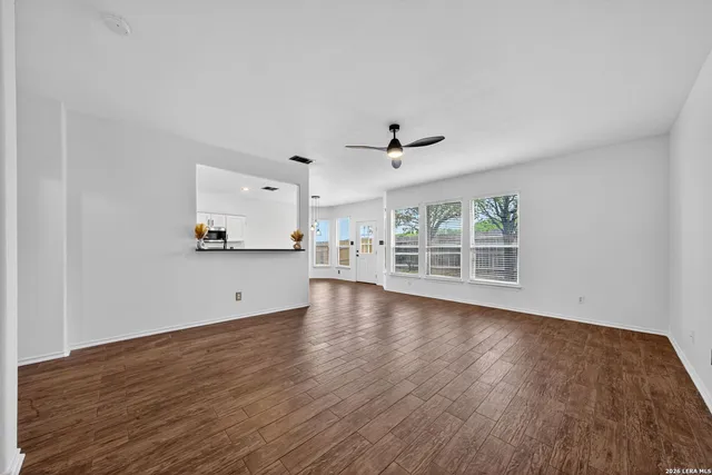 a view of a kitchen with wooden floor and windows