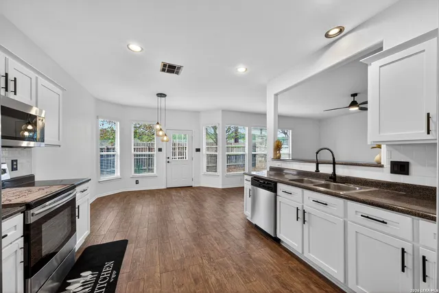 a kitchen with a sink stove and cabinets
