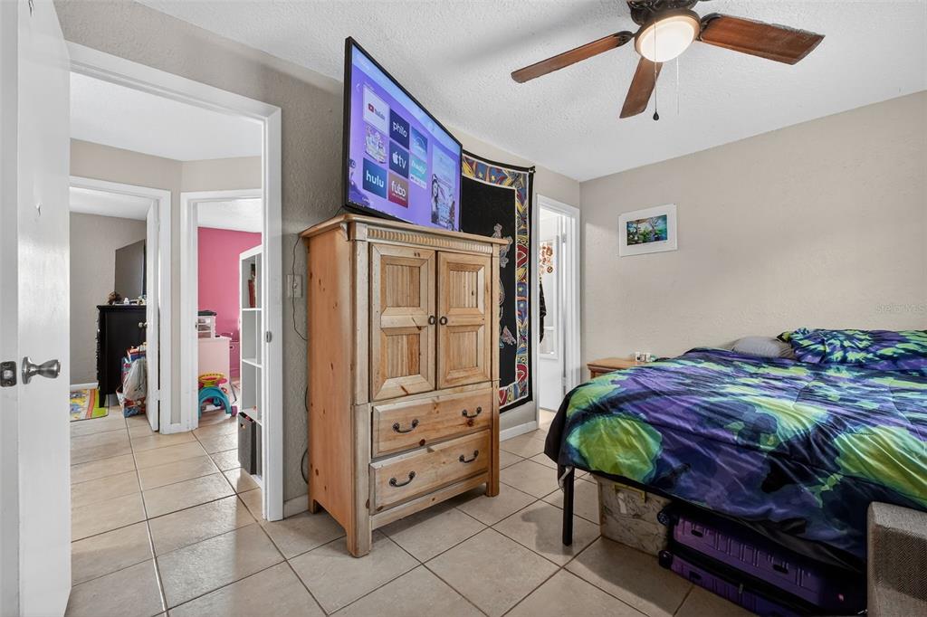1644 Ruth Street Cocoa, FL 32926 - Photo 4 of 38 a bedroom with furniture and a chandelier
