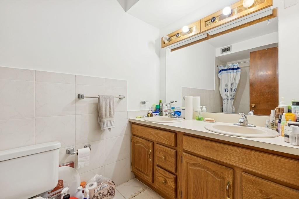 94 Beaconsfield Road, Unit 201 Brookline, MA 02445 - Photo 11 of 13 a spacious bathroom with a sink mirror vanity and toilet