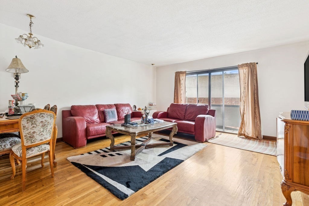 94 Beaconsfield Road, Unit 201 Brookline, MA 02445 - Photo 2 of 13 a living room with furniture and a window