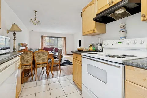 a kitchen with appliances cabinets and a table