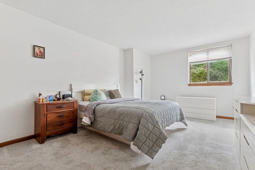 94 Beaconsfield Road, Unit 201 Brookline, MA 02445 - Photo 7 of 13 a spacious bedroom with a bed and a window
