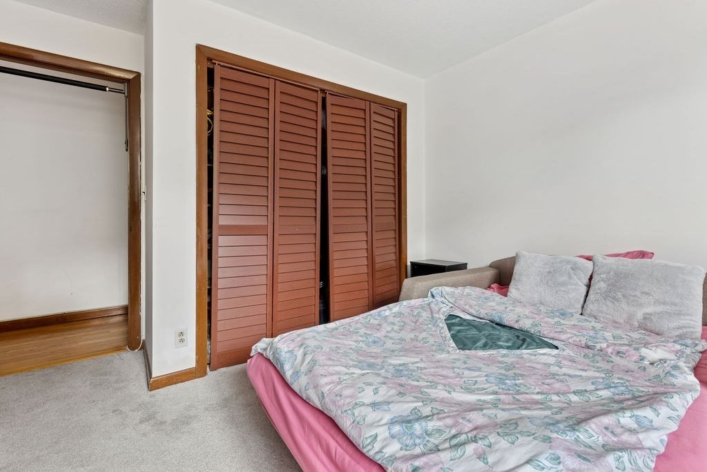 94 Beaconsfield Road, Unit 201 Brookline, MA 02445 - Photo 10 of 13 a bedroom with a bed and a night stand