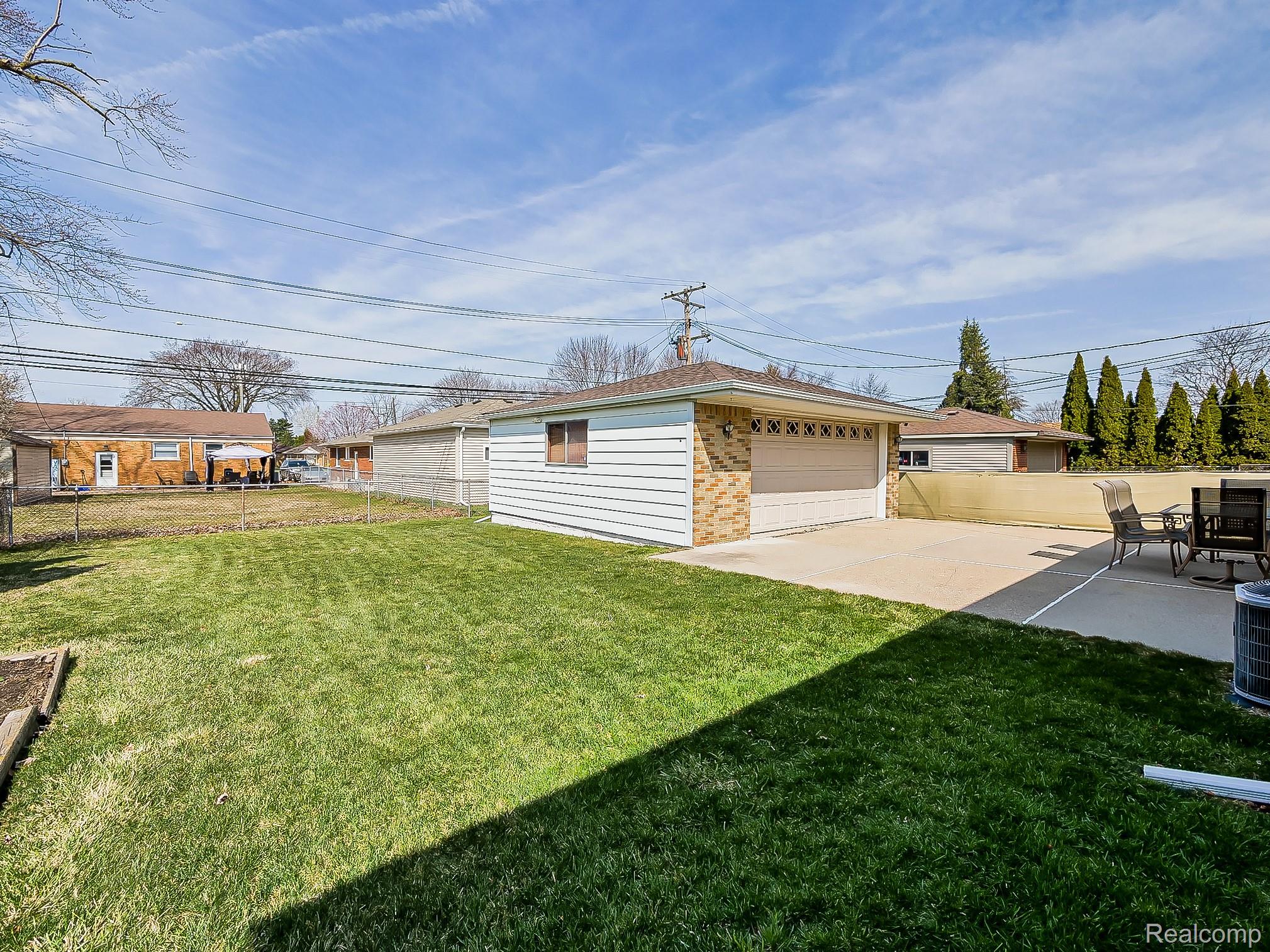 8634 Allen Road Allen Park, MI 48101 - Photo 32 of 38 Fenced yard with an outdoor structure, a garage, and a patio
