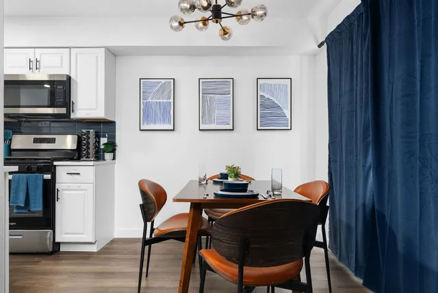 a dining room with furniture and wooden floor
