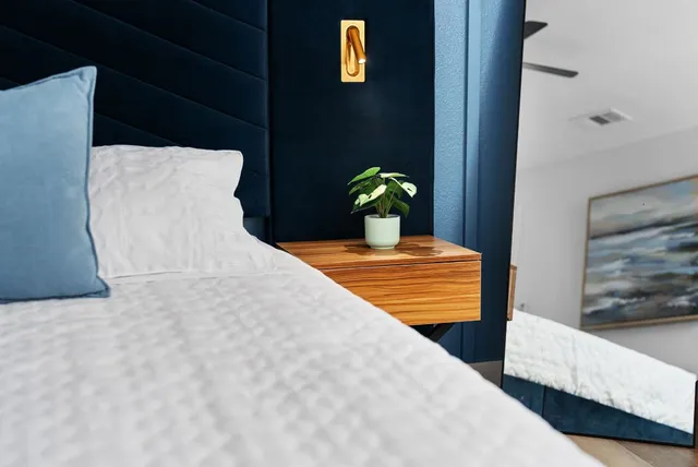 a view of a bedroom with a bed and potted plant