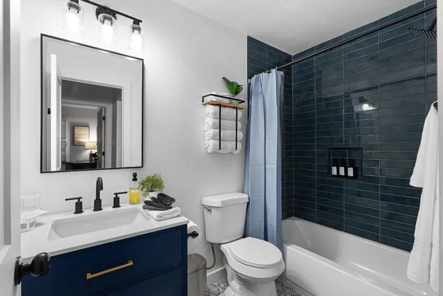 a bathroom with a sink toilet and shower