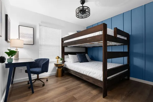 a bedroom with a bed and a chandelier