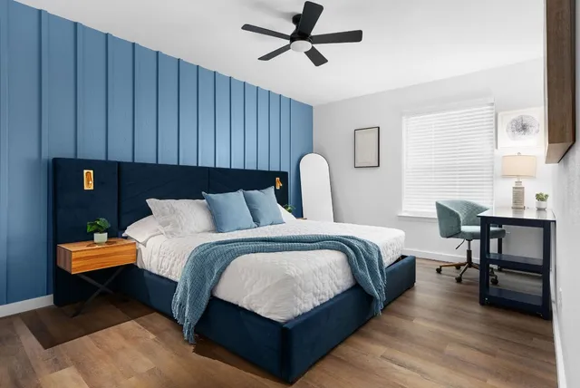 a bed room with a bed window and a table