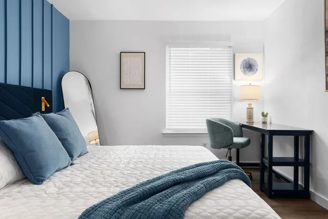 a bedroom with bed and a window