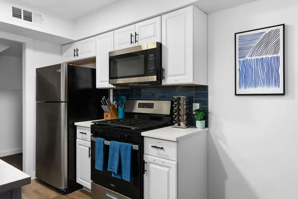 a kitchen with a refrigerator stove and microwave