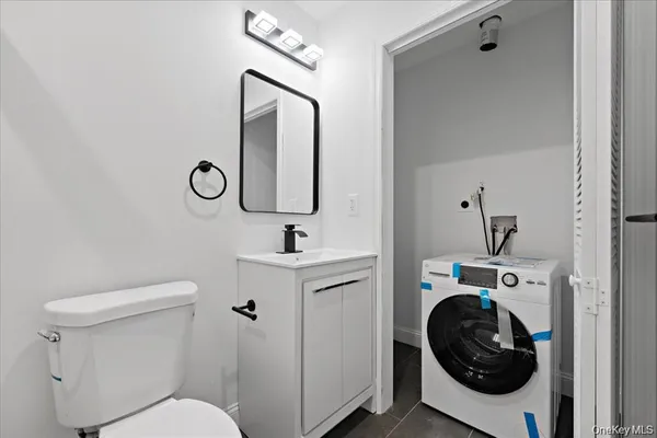 a bathroom with a toilet sink and mirror