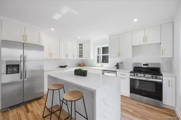 a kitchen with a stove a refrigerator and a cabinets