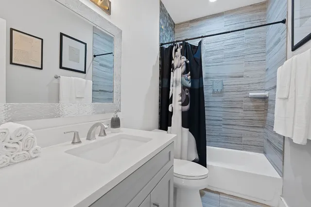 a bathroom with a sink toilet and shower