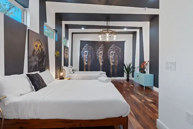 a bedroom with a bed and a large mirror