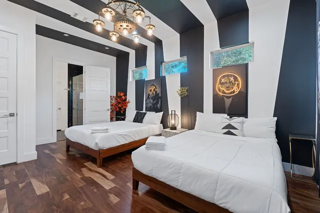 a bedroom with two beds and a table