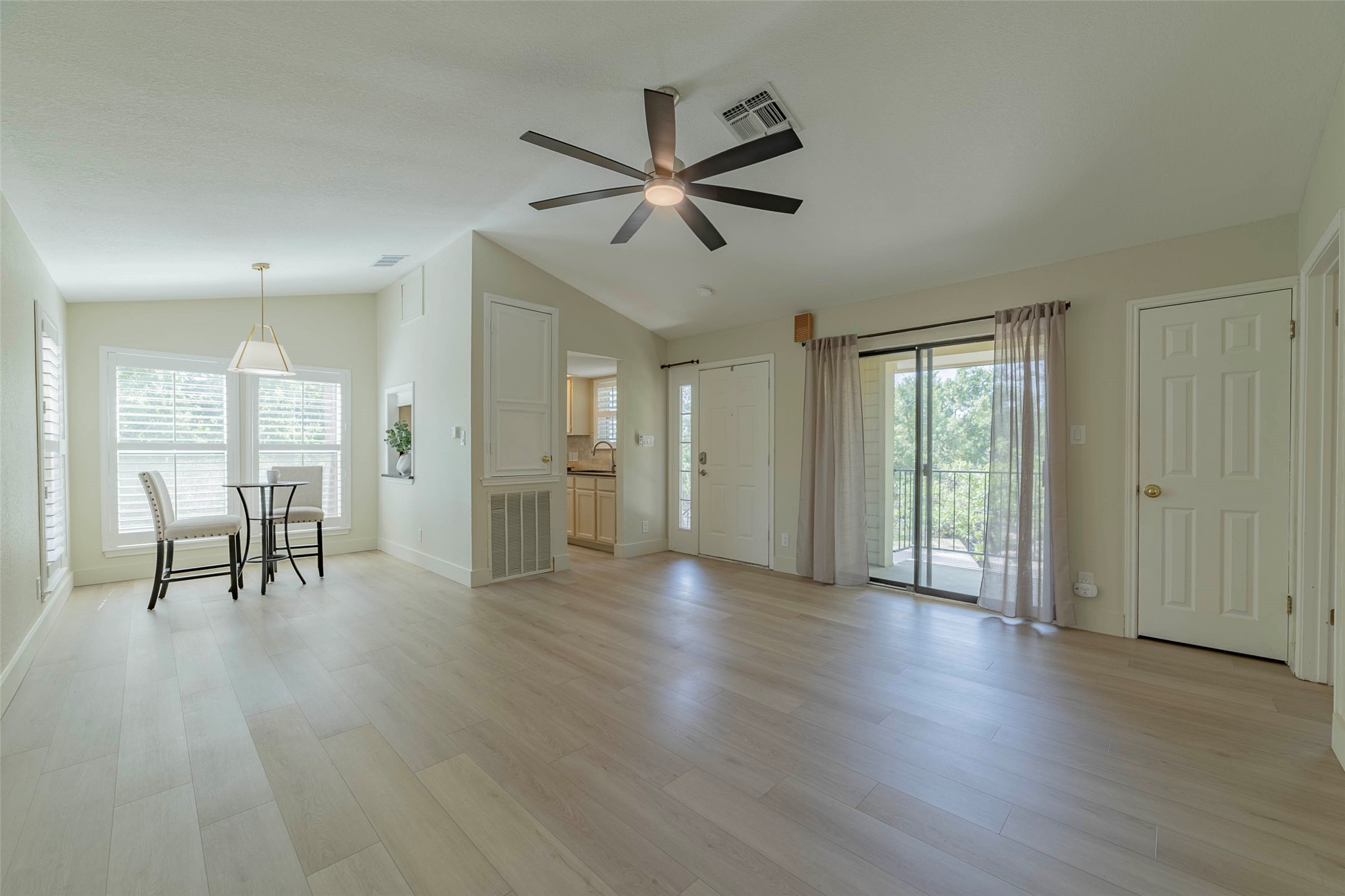 2500 Quarry Road, Unit 5 Austin, TX 78703 - Photo 23 of 23 a view of an empty room with wooden floor and a window