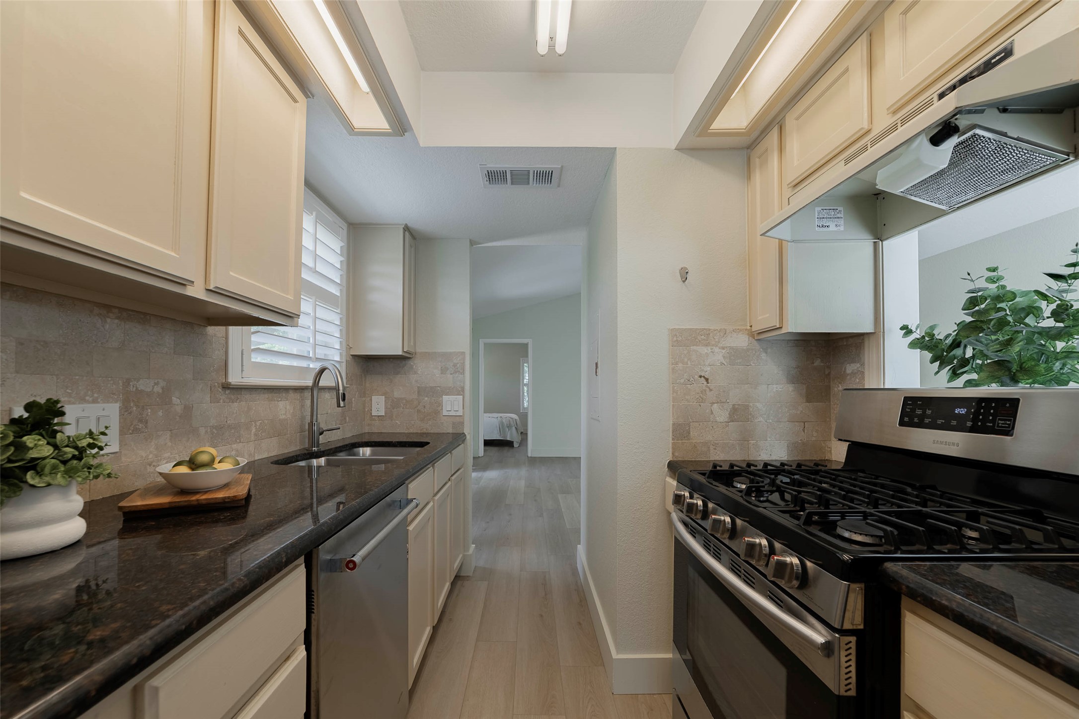 2500 Quarry Road, Unit 5 Austin, TX 78703 - Photo 8 of 23 a kitchen with stainless steel appliances granite countertop a sink stove and cabinets