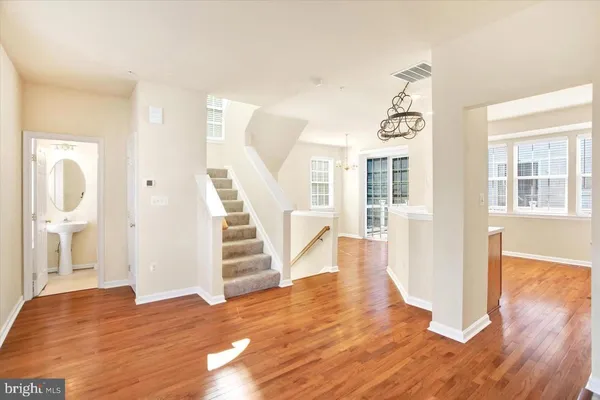 a view of a room with wooden floors and window