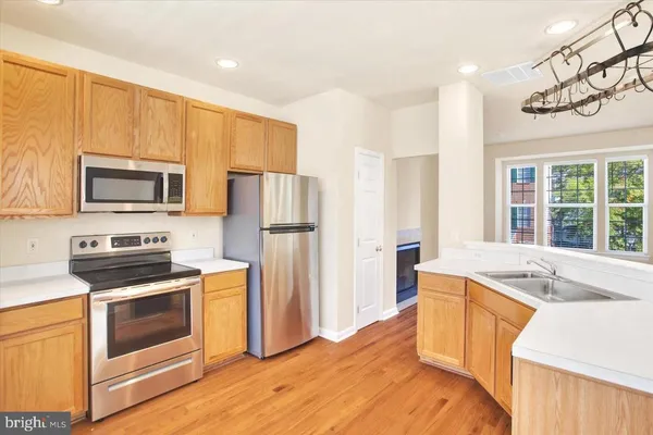 a kitchen with a sink stove and refrigerator