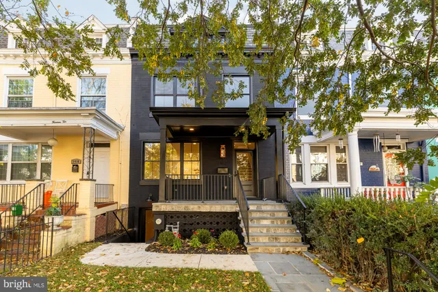 a front view of a building with a garden