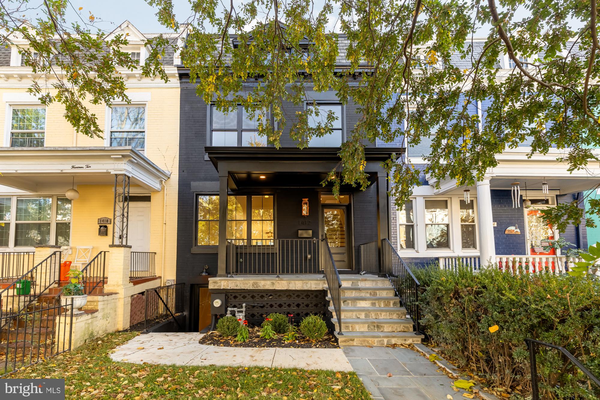 a front view of a building with a garden