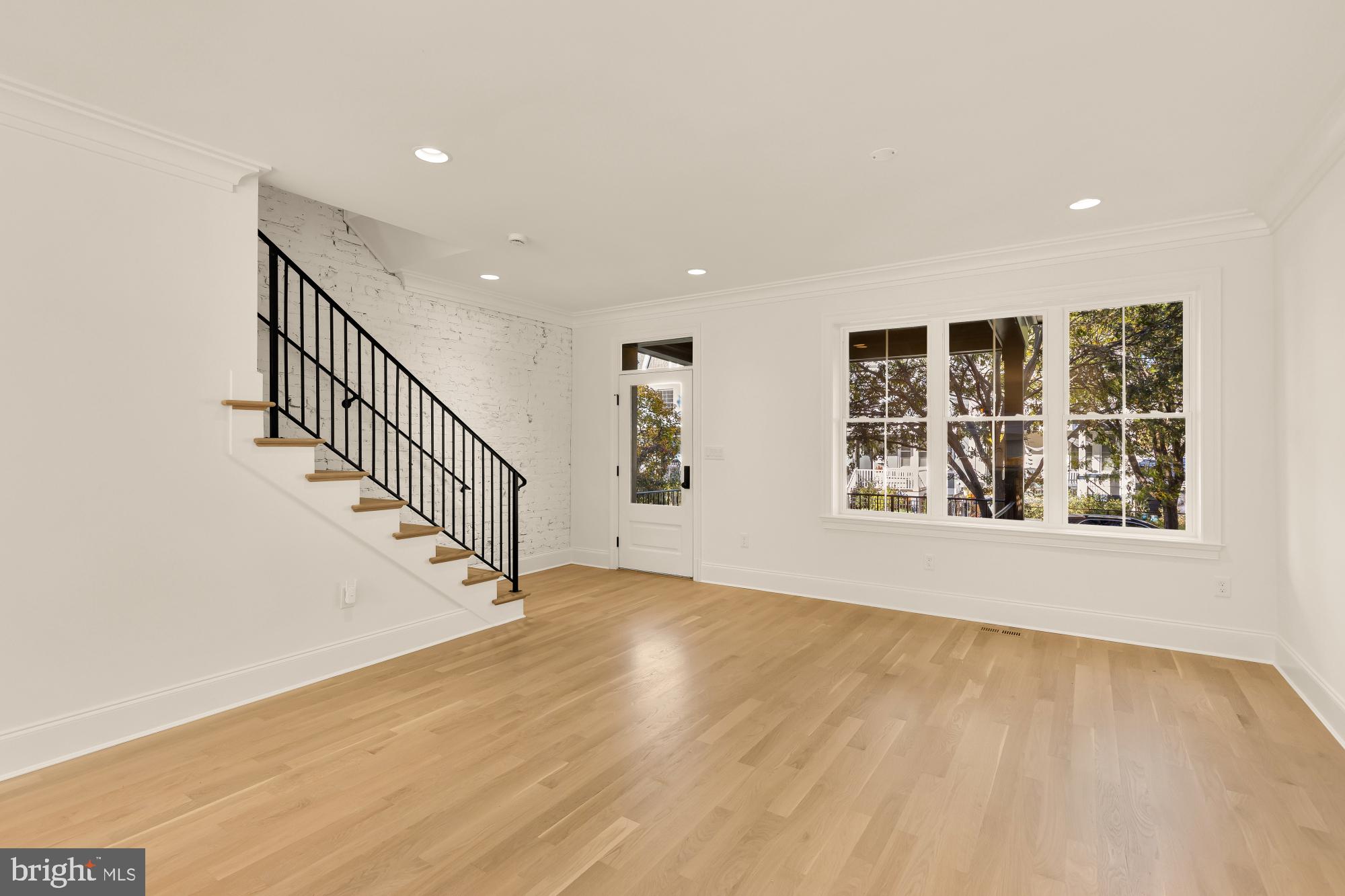 1412 Perry Place Northwest Washington, DC 20010 - Photo 11 of 52 a view of an empty room with wooden floor and a window