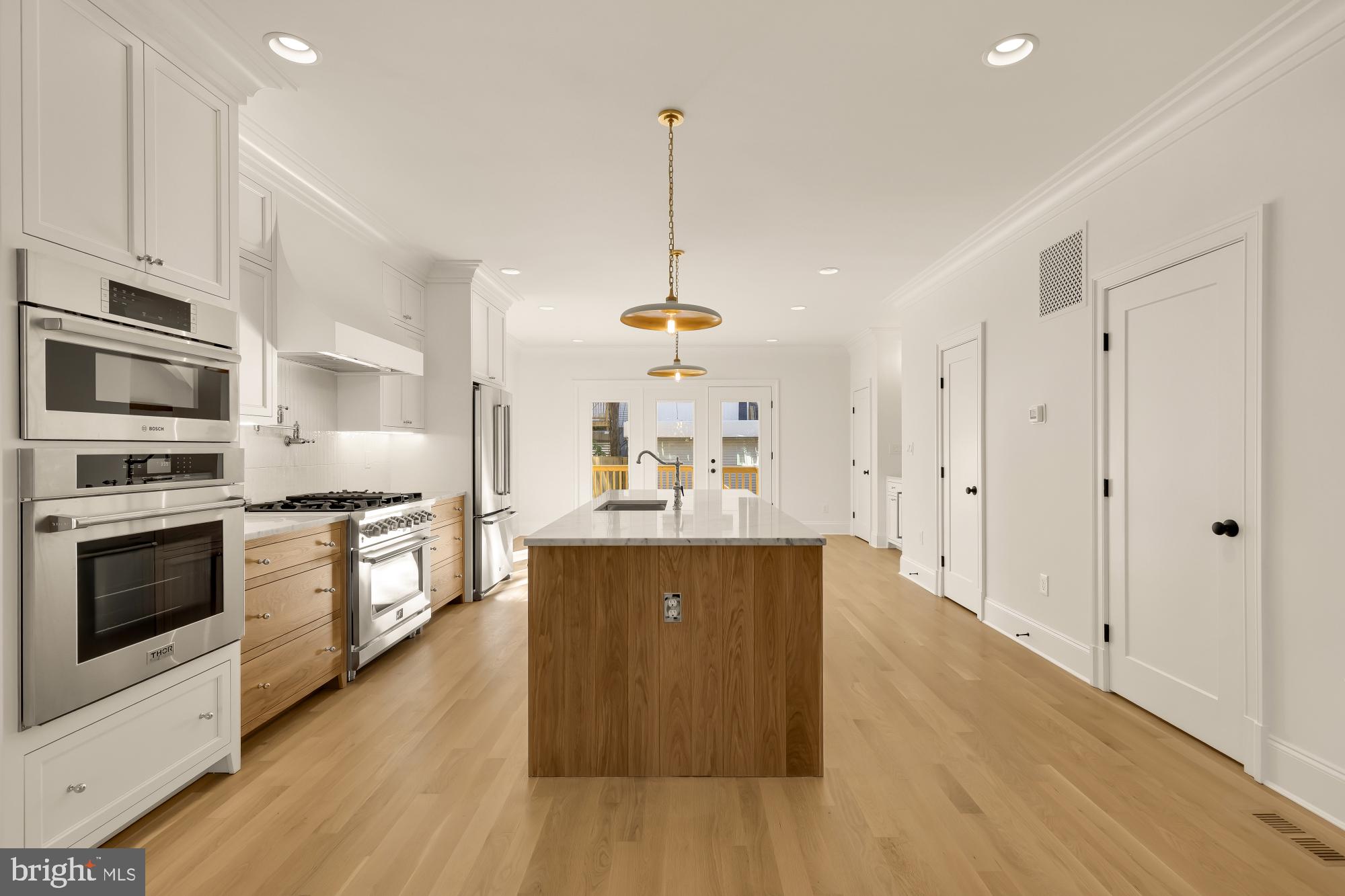 1412 Perry Place Northwest Washington, DC 20010 - Photo 12 of 52 a large kitchen with stainless steel appliances granite countertop a stove a sink dishwasher and a refrigerator with wooden floor
