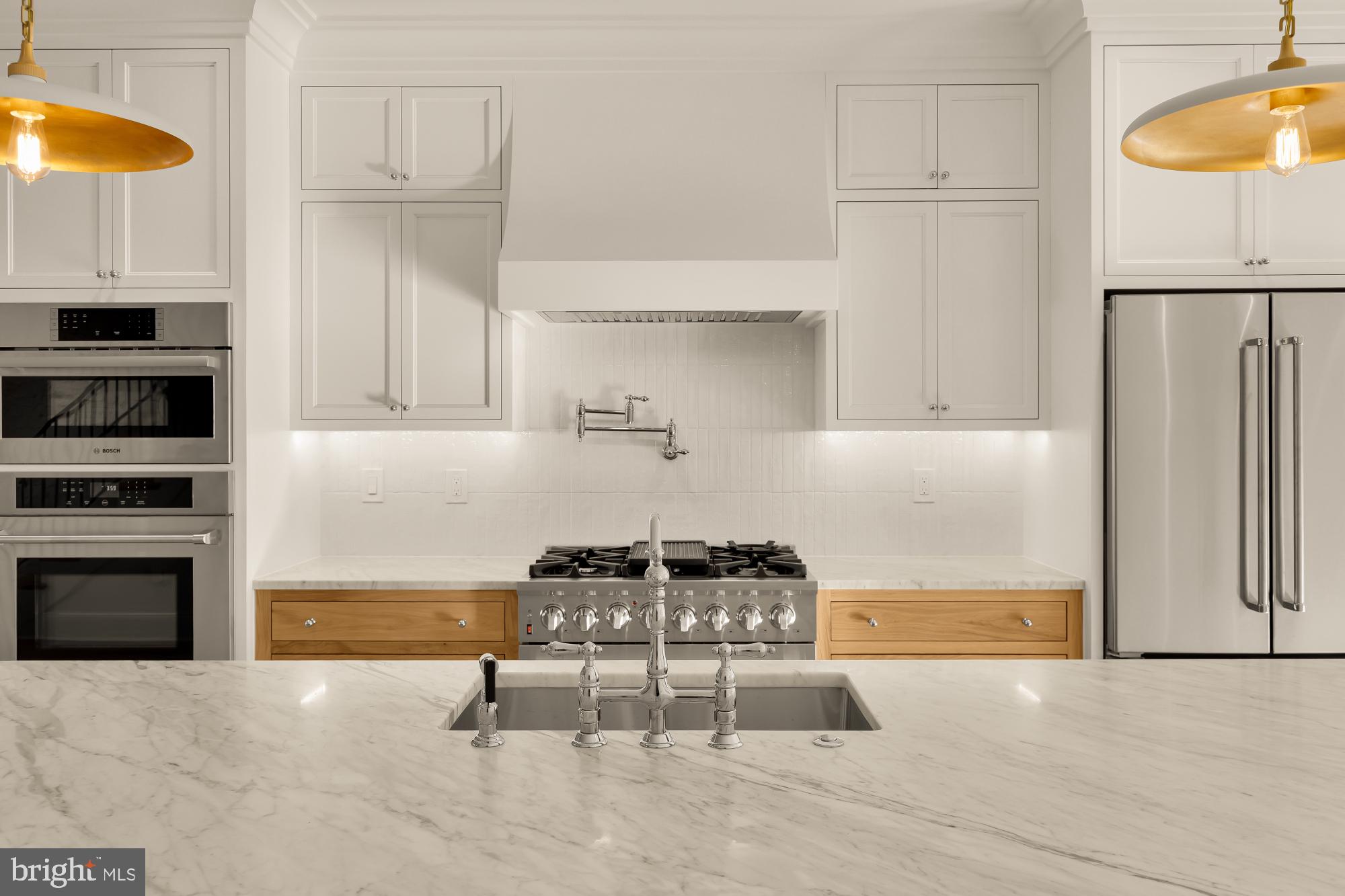 1412 Perry Place Northwest Washington, DC 20010 - Photo 16 of 52 a kitchen with cabinets and chairs