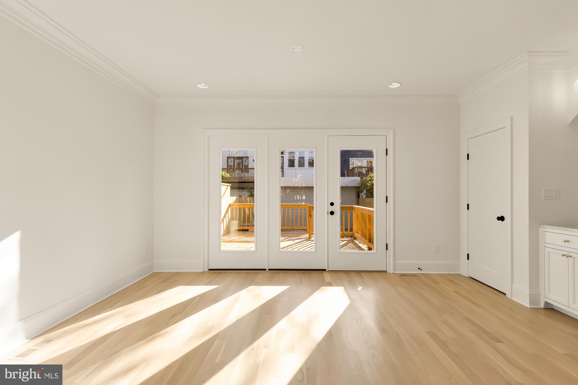 1412 Perry Place Northwest Washington, DC 20010 - Photo 23 of 52 a view of an empty room with wooden floor and a window