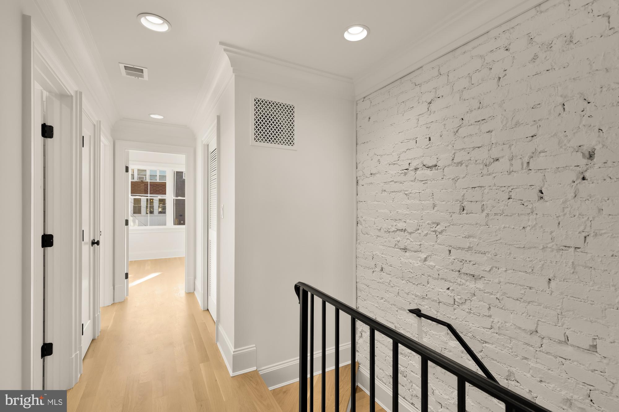 1412 Perry Place Northwest Washington, DC 20010 - Photo 26 of 52 a view of a hallway with wooden floor and staircase