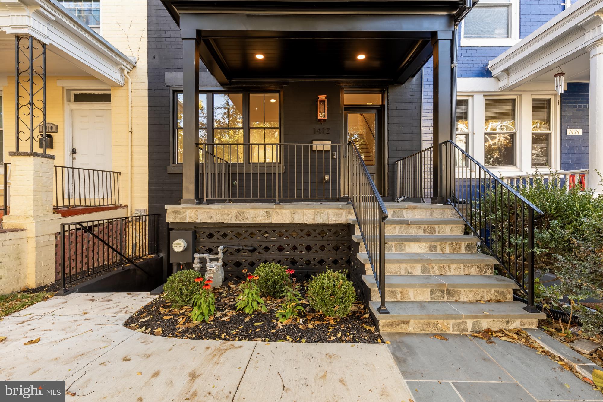 1412 Perry Place Northwest Washington, DC 20010 - Photo 3 of 52 a view of a house with large windows and flower plants